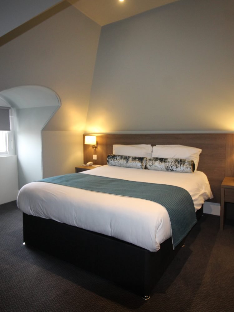 A hotel room with an attic.
