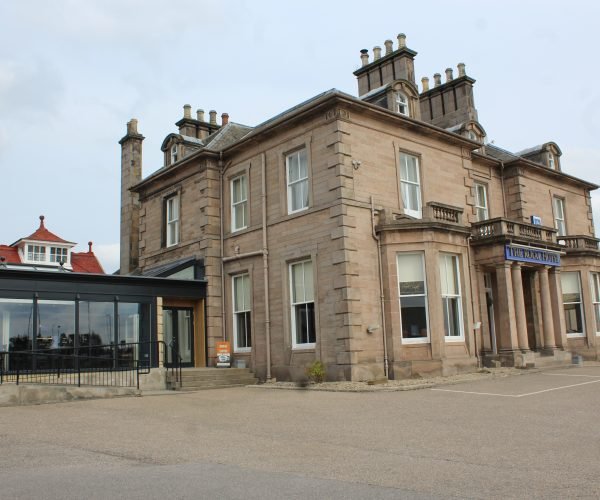 A large building with a lot of windows, perfect for a breakfast restaurant.