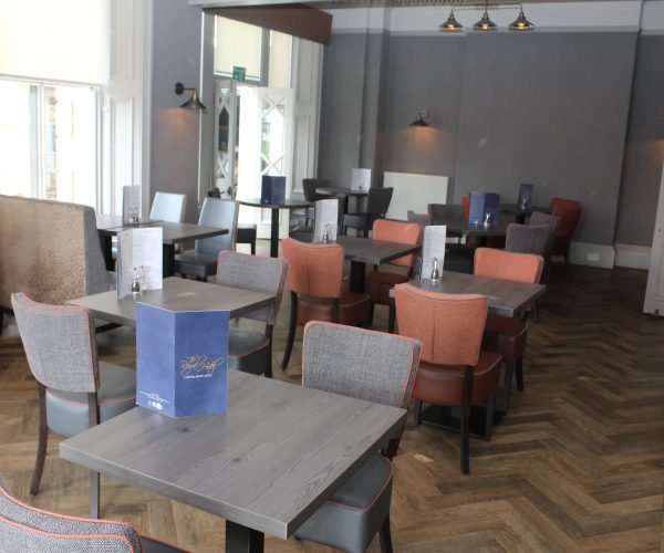 Elgin restaurant featuring tables and chairs for guests to enjoy their dining experience.